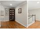 Hallway with hardwood floors and picture frames at 4905 Village Green Dr, Roswell, GA 30075