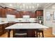 Open kitchen with island, stainless appliances, and stylish light fixture at 4905 Village Green Dr, Roswell, GA 30075