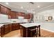 Elegant kitchen featuring custom cabinets, an island with seating, and modern appliances at 4905 Village Green Dr, Roswell, GA 30075