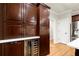 Spacious kitchen boasts wine storage and beautiful wood cabinets at 4905 Village Green Dr, Roswell, GA 30075