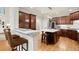 Modern kitchen featuring dark wood cabinets, a white countertop, and an island with seating at 4905 Village Green Dr, Roswell, GA 30075