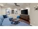 Spacious living room featuring a tray ceiling, flat screen, and comfortable furniture at 4905 Village Green Dr, Roswell, GA 30075