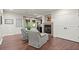Sitting room with arm chairs, fireplace, and view to the backyard at 4905 Village Green Dr, Roswell, GA 30075