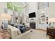 Sophisticated living room featuring built-in shelves, fireplace, and large windows at 4905 Village Green Dr, Roswell, GA 30075
