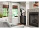 Comfortable living room boasts a decorative fireplace, stylish furnishings, and bright natural light at 4905 Village Green Dr, Roswell, GA 30075