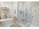 Luxurious bathroom with freestanding tub, glass-enclosed shower, modern fixtures, and elegant design at 4905 Village Green Dr, Roswell, GA 30075