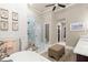 Elegant bathroom featuring glass shower, vanity with double sinks, garden tub, and natural light at 4905 Village Green Dr, Roswell, GA 30075