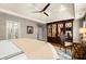 Bedroom with trey ceiling, large mirrored wardrobe, ceiling fan and light colored bedding at 4905 Village Green Dr, Roswell, GA 30075