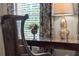 Cozy office nook features natural light, a decorative lamp, and custom window treatments at 4905 Village Green Dr, Roswell, GA 30075