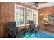 Covered porch with chairs and a fan, offering a relaxing outdoor space at 4905 Village Green Dr, Roswell, GA 30075