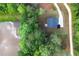 Areal view of new home surrounded by lush greenery, pond and long driveway at 115 Haven Brook Way, Douglasville, GA 30134