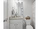 Clean bathroom features a vanity with granite countertop, a large mirror, and neutral-toned decor at 115 Haven Brook Way, Douglasville, GA 30134