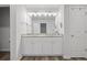 Dual sink bathroom vanity with white cabinetry, granite counters, and ample lighting at 115 Haven Brook Way, Douglasville, GA 30134