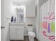Charming bathroom with white vanity, granite countertop, updated fixtures, and decorative shower curtain and cabinet at 115 Haven Brook Way, Douglasville, GA 30134