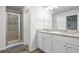 Bathroom features a glass enclosed shower and dual granite vanity at 115 Haven Brook Way, Douglasville, GA 30134