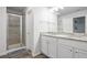 Clean bathroom features a shower and vanity with granite countertop and double sinks at 115 Haven Brook Way, Douglasville, GA 30134