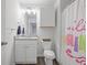 Bright bathroom features a modern vanity with granite countertop and stylish shower curtain at 115 Haven Brook Way, Douglasville, GA 30134
