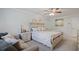 Bright bedroom features a couch, a large bed, and a decorative end table and artwork at 115 Haven Brook Way, Douglasville, GA 30134
