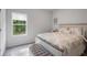 Bright bedroom featuring a large window, soft carpet, and neutral-toned decor and bedding at 115 Haven Brook Way, Douglasville, GA 30134