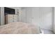 Comfortable bedroom with soft, patterned bedding and a wooden dresser and TV at 115 Haven Brook Way, Douglasville, GA 30134
