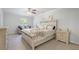 Relaxing bedroom with neutral tones, decorative bed, and side table with lamp and drawer storage at 115 Haven Brook Way, Douglasville, GA 30134