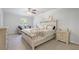 Bright bedroom featuring a decorative ceiling fan, neutral color palette, and comfortable seating area at 115 Haven Brook Way, Douglasville, GA 30134