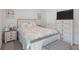 Comfortable bedroom features a decorative bed frame and side tables with ample natural light at 115 Haven Brook Way, Douglasville, GA 30134