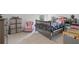 bedroom featuring a plush chair, a crib, and shelves filled with books and toys at 115 Haven Brook Way, Douglasville, GA 30134