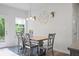 Cozy dining room with a wooden table, gray chairs, and a modern light fixture at 115 Haven Brook Way, Douglasville, GA 30134