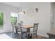 Comfortable dining room with a modern light fixture and view to the outdoors at 115 Haven Brook Way, Douglasville, GA 30134