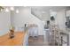 Open-concept dining room featuring a wooden table, gray chairs, and hardwood floors at 115 Haven Brook Way, Douglasville, GA 30134