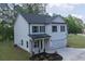 Lovely home with white siding, black shutters, a manicured lawn and attached two car garage at 115 Haven Brook Way, Douglasville, GA 30134