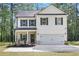 Charming two-story home with white siding, black shutters, and attached two car garage at 115 Haven Brook Way, Douglasville, GA 30134