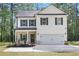 Charming two-story home with manicured landscaping, a two-car garage, and covered entry at 115 Haven Brook Way, Douglasville, GA 30134
