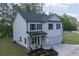 Two-story home featuring white siding, black shutters, and an attached two-car garage at 115 Haven Brook Way, Douglasville, GA 30134