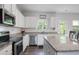 Stylish kitchen with white cabinets, stainless steel appliances, and granite countertops at 115 Haven Brook Way, Douglasville, GA 30134