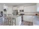 Bright kitchen features white cabinets, stainless steel appliances, and granite countertops at 115 Haven Brook Way, Douglasville, GA 30134