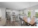 Spacious kitchen features white cabinets, stainless appliances, breakfast bar, and adjacent dining area at 115 Haven Brook Way, Douglasville, GA 30134