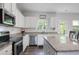 Modern kitchen with a large island, stainless appliances, and granite countertops at 115 Haven Brook Way, Douglasville, GA 30134