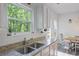 Granite countertops and a stainless steel sink in a modern kitchen with a window view at 115 Haven Brook Way, Douglasville, GA 30134