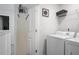 Laundry area featuring a white washer and dryer plus storage at 115 Haven Brook Way, Douglasville, GA 30134
