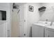 Functional laundry room equipped with modern washer and dryer and ironing equipment at 115 Haven Brook Way, Douglasville, GA 30134