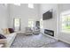 Inviting living room with high ceilings, a modern fireplace, and ample seating at 115 Haven Brook Way, Douglasville, GA 30134