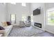 Bright living room with high ceilings, a modern fireplace, and comfortable seating at 115 Haven Brook Way, Douglasville, GA 30134