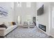 Bright living room with high ceilings, a modern fireplace, and comfortable seating at 115 Haven Brook Way, Douglasville, GA 30134