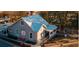 Charming gray farmhouse-style building with a white roof, surrounded by lush trees at 3350 Cranston Ln, Kennesaw, GA 30144