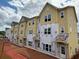 New townhouse exterior featuring yellow siding, multiple windows, and well-defined entrances at 3350 Cranston Ln, Kennesaw, GA 30144