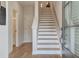 Inviting foyer with staircase, light hardwood floors, and glass-paneled front door at 3350 Cranston Ln, Kennesaw, GA 30144