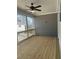 Screened porch with wood flooring, gray wood paneled wall and fan at 3350 Cranston Ln, Kennesaw, GA 30144