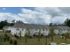 Rear exterior view of townhomes with fenced yards and young trees lining the landscaping at 3350 Cranston Ln, Kennesaw, GA 30144